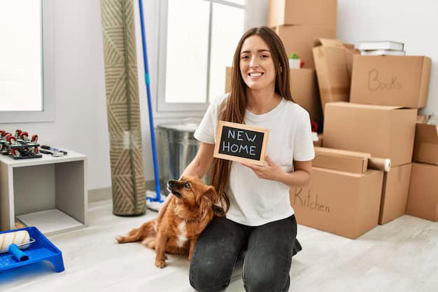 Young hispanic woman holding new home blackboard sitting on floor with dog